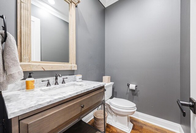 6920 Clivdon Mews, New Albany, OH 43054 - half bathroom featuring crown molding, vanity, toilet, wood finished floors, and baseboards