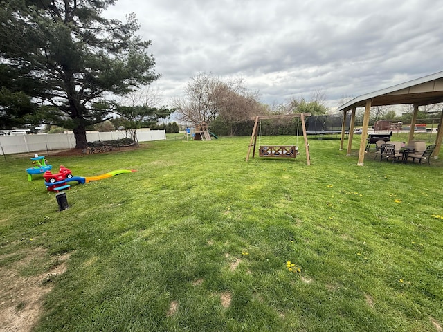 view of yard with fence, a gazebo, and a playground