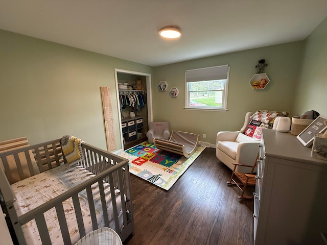 bedroom with a closet, baseboards, and dark wood-style flooring
