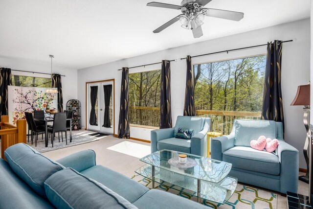 living room with carpet floors, plenty of natural light, and a ceiling fan