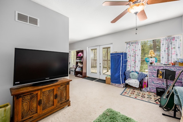 carpeted living room with visible vents, ceiling fan, and french doors
