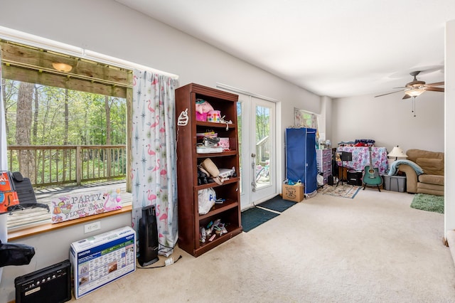 interior space with carpet floors and a ceiling fan