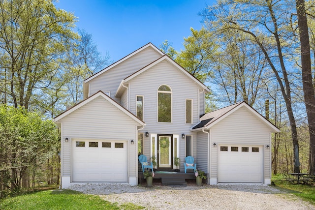 traditional home featuring an attached garage and driveway