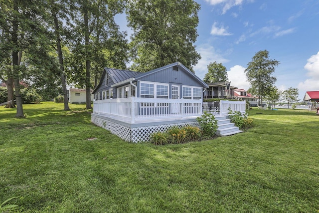 13384 Orchard Is NE, Millersport, OH 43046 - back of house featuring a standing seam roof, a lawn, a metal roof, and a deck