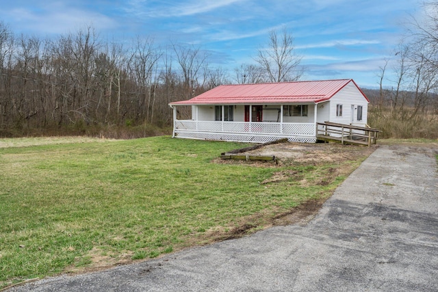 751 Bobo Rd, Beaver, OH 45613 - view of front of house featuring a porch, metal roof, a front lawn, and aphalt driveway