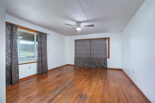 751 Bobo Rd, Beaver, OH 45613 - empty room with a textured ceiling, wood finished floors, baseboards, and a ceiling fan