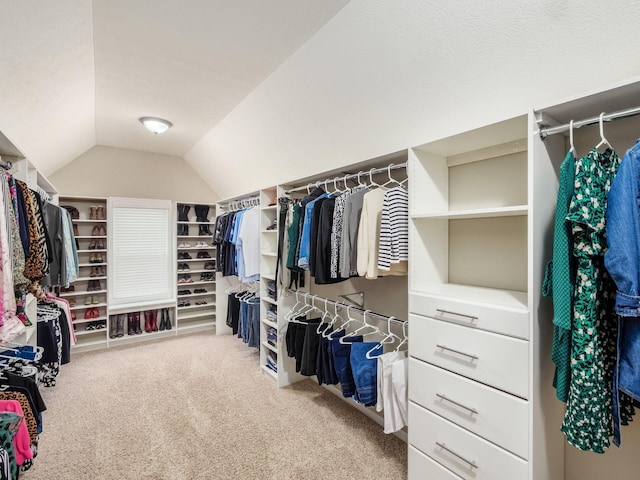 spacious closet featuring vaulted ceiling and carpet floors