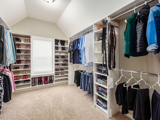 spacious closet with vaulted ceiling and carpet flooring