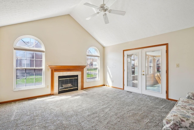 5955 Glen Village Dr, Dublin, OH 43016 - unfurnished living room with baseboards, french doors, a ceiling fan, carpet floors, and a tile fireplace