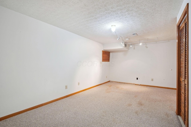 5955 Glen Village Dr, Dublin, OH 43016 - empty room with baseboards, rail lighting, carpet, and a textured ceiling