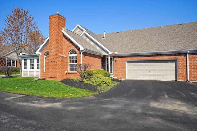 5955 Glen Village Dr, Dublin, OH 43016 - view of front facade with a chimney, a shingled roof, a garage, and aphalt driveway