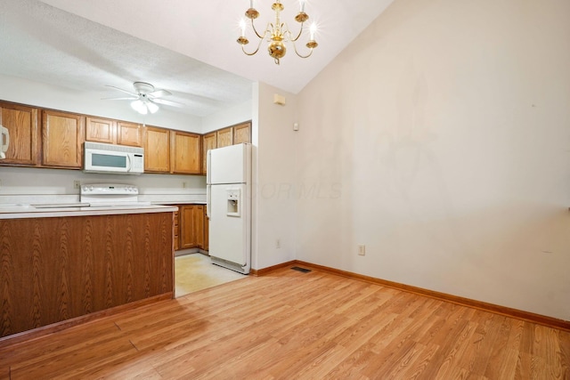 5955 Glen Village Dr, Dublin, OH 43016 - kitchen with brown cabinetry, light wood-type flooring, ceiling fan with notable chandelier, and white appliances