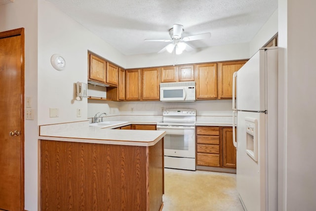 5955 Glen Village Dr, Dublin, OH 43016 - kitchen with a sink, a ceiling fan, white appliances, a peninsula, and a textured ceiling