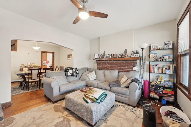 1287 City Park Ave, Columbus, OH 43206 - living room featuring wood finished floors, a ceiling fan, and arched walkways