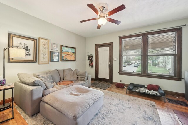 1287 City Park Ave, Columbus, OH 43206 - living room with ceiling fan, wood finished floors, and baseboards