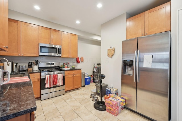 1287 City Park Ave, Columbus, OH 43206 - kitchen with appliances with stainless steel finishes, a sink, tasteful backsplash, light tile patterned floors, and recessed lighting