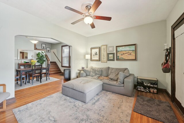 1287 City Park Ave, Columbus, OH 43206 - living room featuring stairway, ceiling fan, wood finished floors, and baseboards