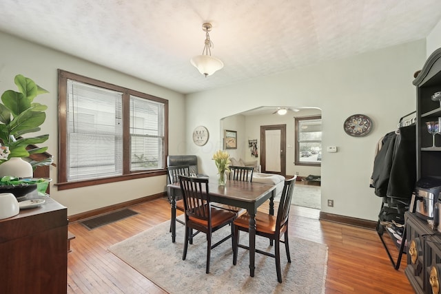 1287 City Park Ave, Columbus, OH 43206 - dining area with arched walkways, wood-type flooring, and baseboards