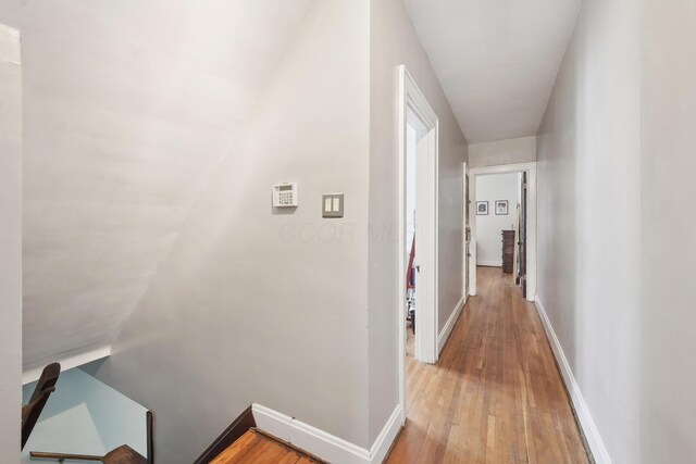 1287 City Park Ave, Columbus, OH 43206 - hall with light wood-style floors, baseboards, and an upstairs landing