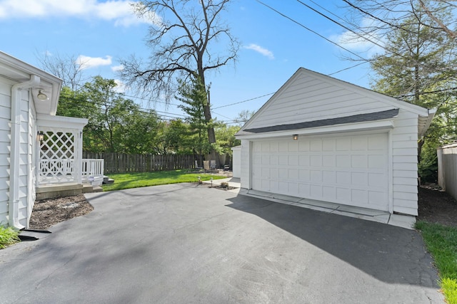 detached garage featuring fence