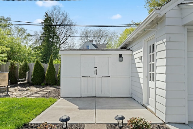view of shed with fence