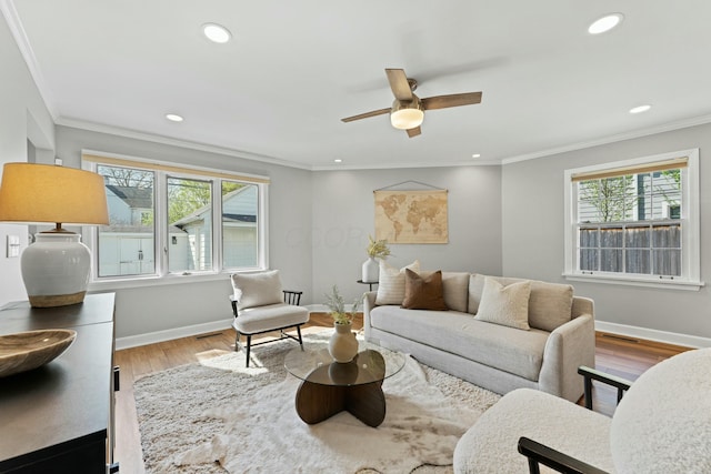 living room with crown molding, wood finished floors, ceiling fan, baseboards, and recessed lighting