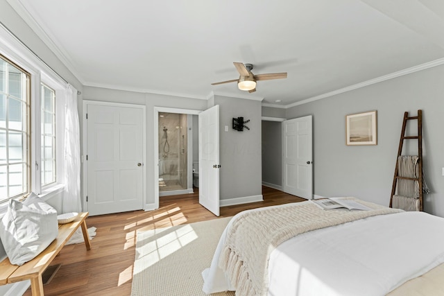 bedroom featuring wood finished floors, a ceiling fan, connected bathroom, crown molding, and baseboards