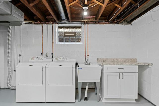 laundry room with washing machine and dryer and cabinet space