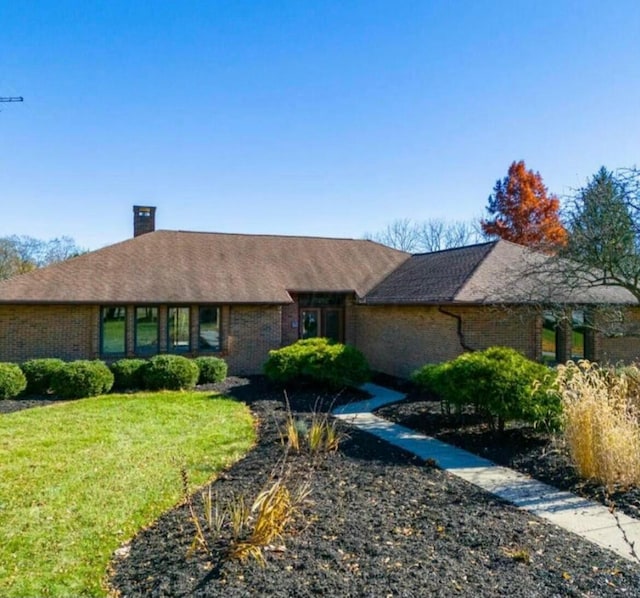 4070 Tradersville Brighton Rd, London, OH 43140 - view of front facade with a chimney, a front lawn, and brick siding