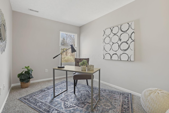 carpeted office with baseboards and visible vents