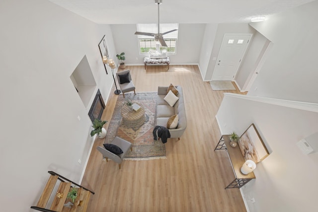 living area with baseboards and wood finished floors