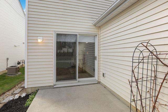 entrance to property featuring a patio area and central AC