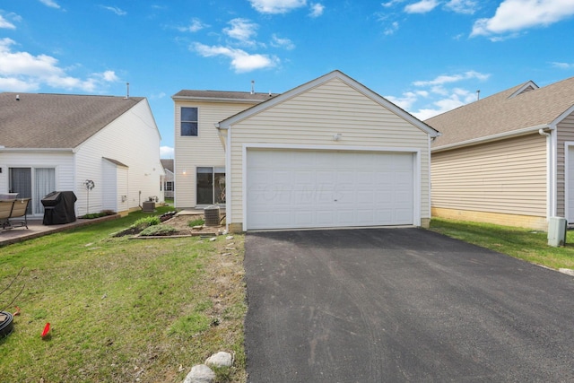 view of front of house with a front yard, driveway, and a garage