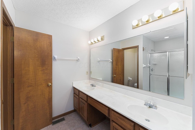 5516 Latrobe St, Westerville, OH 43081 - full bathroom featuring a stall shower, double vanity, toilet, a textured ceiling, and tile patterned floors