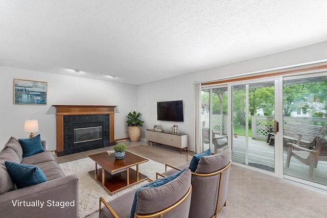5516 Latrobe St, Westerville, OH 43081 - living area featuring a tile fireplace, a textured ceiling, and carpet flooring