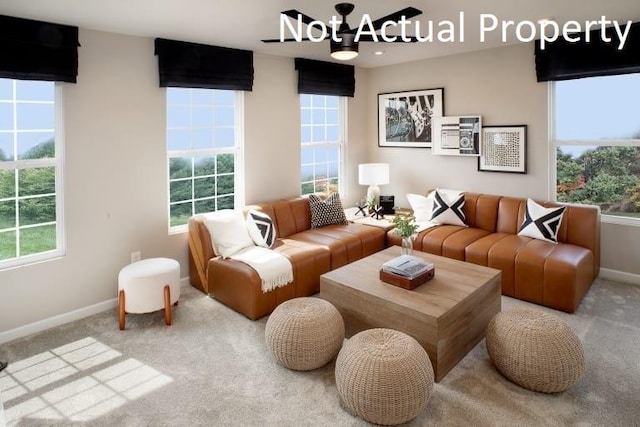 living area featuring a chandelier, carpet flooring, and baseboards