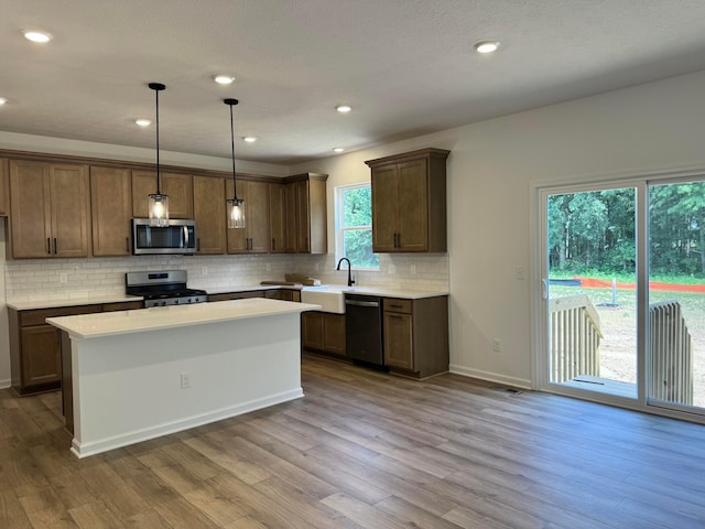 3441 Tender Ave Lot 7157, Powell, OH 43065 - kitchen with stainless steel appliances, wood finished floors, decorative backsplash, and recessed lighting