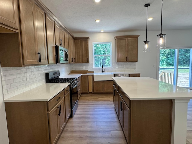 3441 Tender Ave Lot 7157, Powell, OH 43065 - kitchen with appliances with stainless steel finishes, light wood-style floors, recessed lighting, a center island, and backsplash