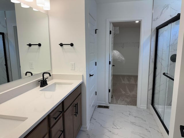 3441 Tender Ave Lot 7157, Powell, OH 43065 - bathroom featuring double vanity, marble finish flooring, a shower stall, and a spacious closet