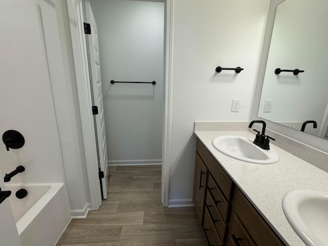3441 Tender Ave Lot 7157, Powell, OH 43065 - bathroom featuring double vanity, wood finished floors, and shower / tub combination