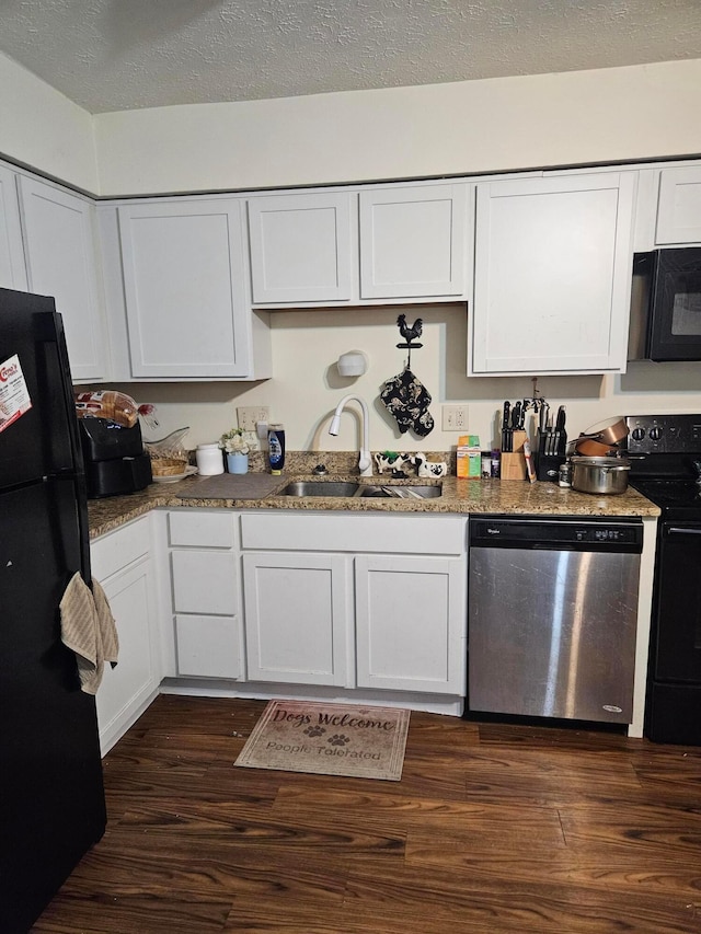 kitchen featuring a sink, black appliances, white cabinetry, and dark wood-type flooring