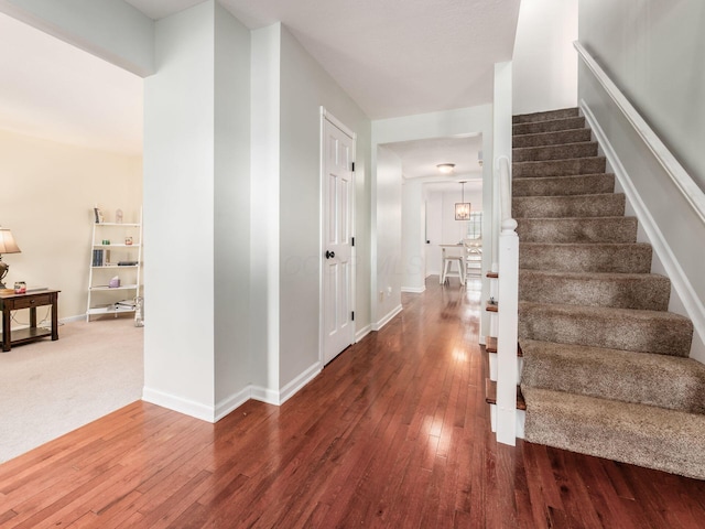 stairs with baseboards and hardwood / wood-style floors
