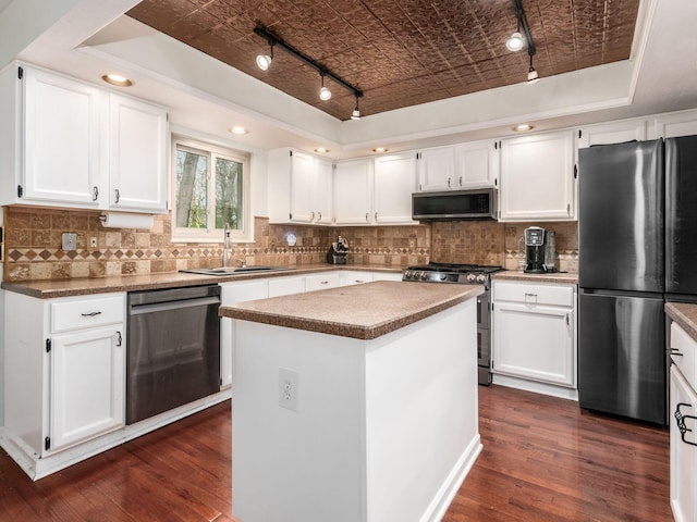 kitchen with stainless steel appliances, an ornate ceiling, a sink, and a raised ceiling