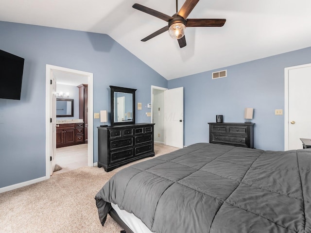 bedroom featuring ensuite bathroom, light colored carpet, vaulted ceiling, visible vents, and baseboards