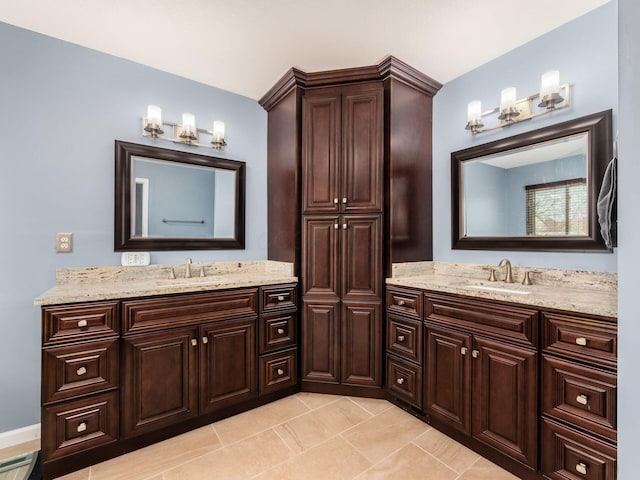 bathroom featuring tile patterned floors, two vanities, and a sink