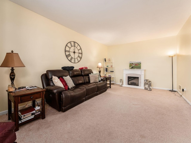 living room with a fireplace with flush hearth, carpet flooring, and baseboards