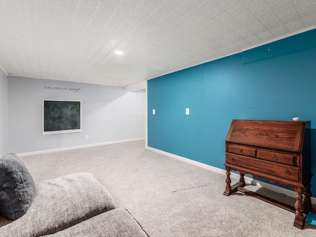 sitting room with baseboards and carpet