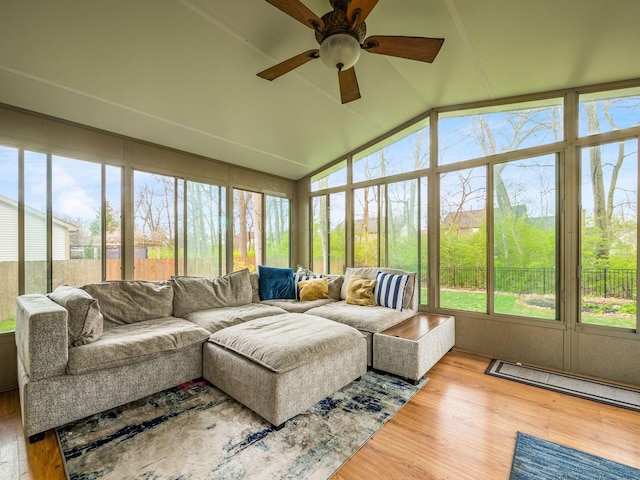 sunroom / solarium with wood finished floors, ceiling fan, lofted ceiling, and an outdoor hangout area