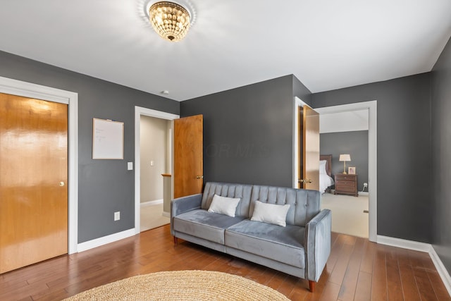 living area with baseboards and hardwood / wood-style floors