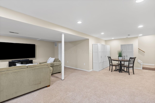 living area with stairway, light carpet, baseboards, visible vents, and recessed lighting